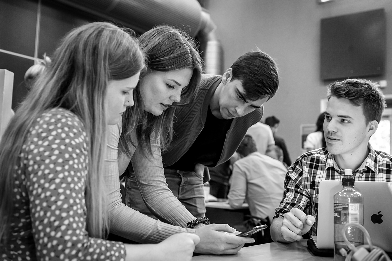 People talking in a group at a table. Photo.