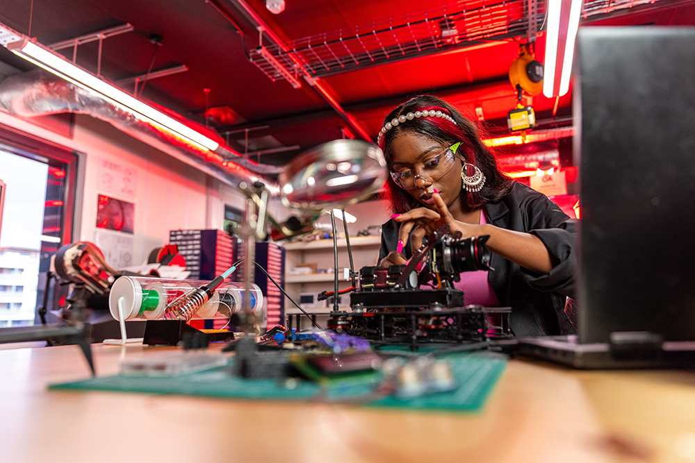 Young Woman working with electronics. Photo.