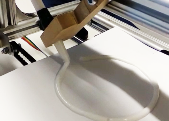 close-up of a liquid being 3d printed. Photo.