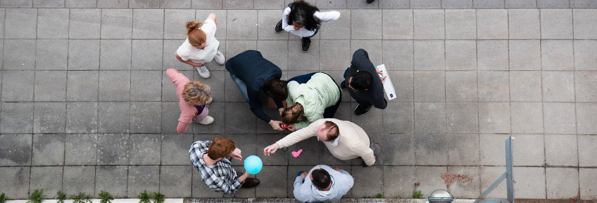 a group of people collaborating outside, seen from above. Photo. 